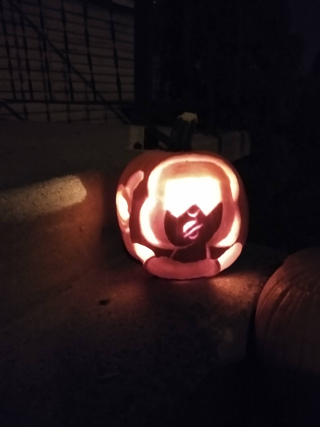 Pumpkin carved with the face of Garnet, a person with sunglasses from "Steven Universe"