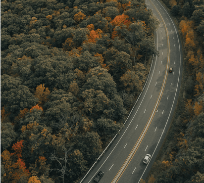 Image of a four land road curving through trees