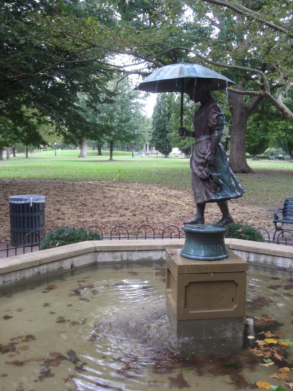 Fountain featuring a girl carrying an umbrella