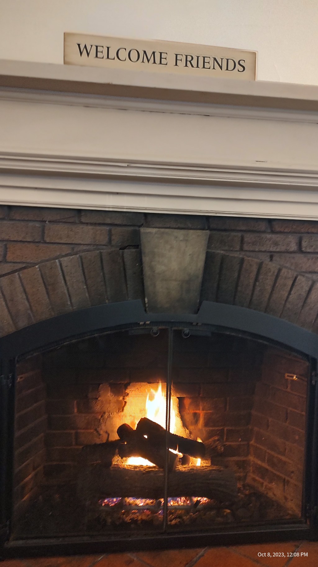 Fireplace with Welcome Friends sign on mantle