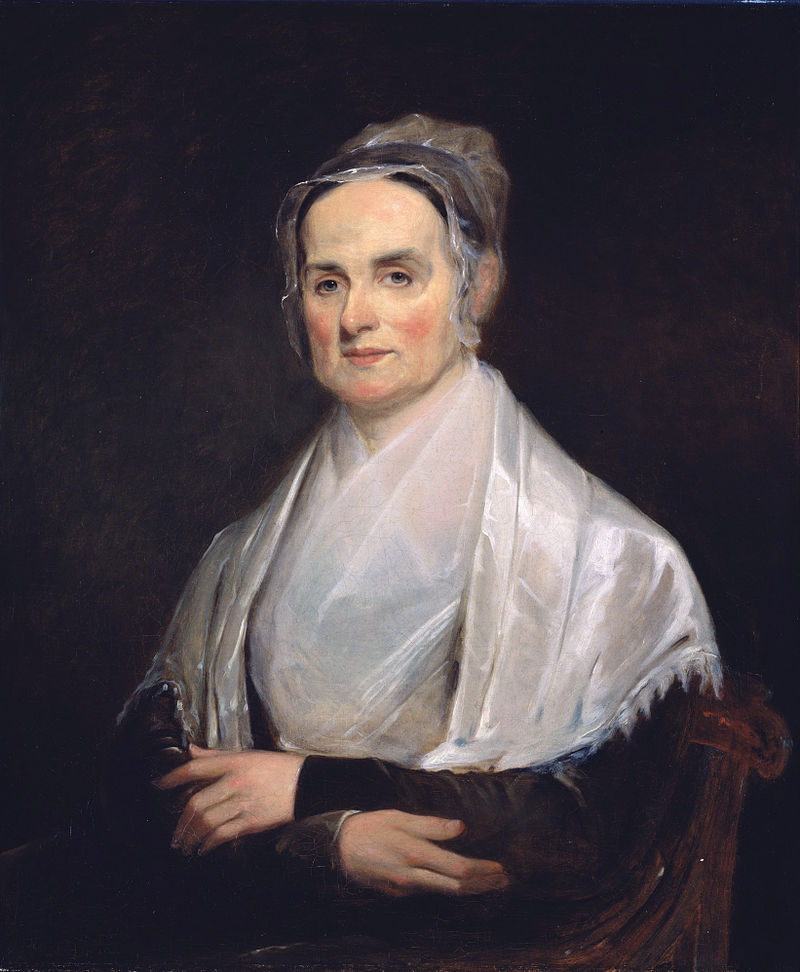 color portrait painting of a white woman wearing 1800s clothing, white shawl, dark dress, white bonnet. She looks at the viewer with a calm face