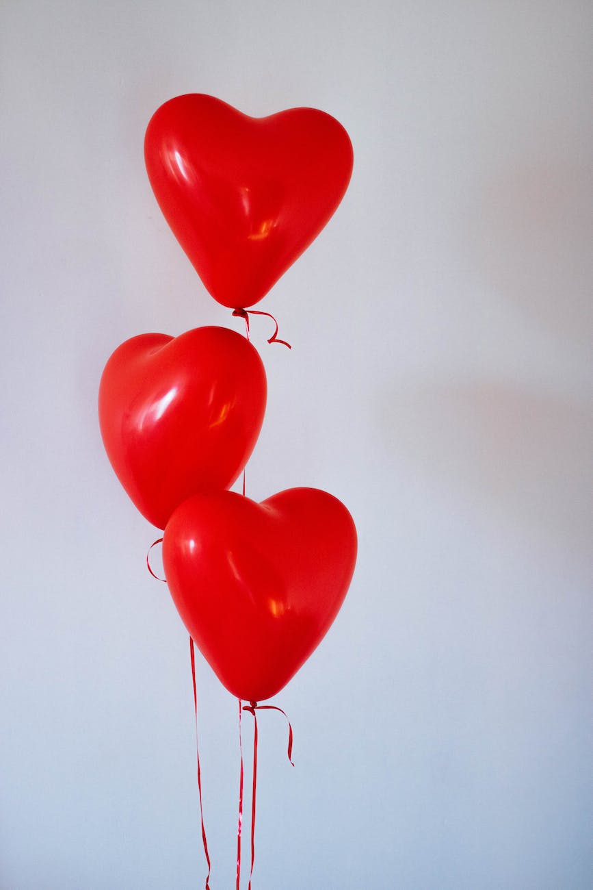 3 heart shaped red balloons