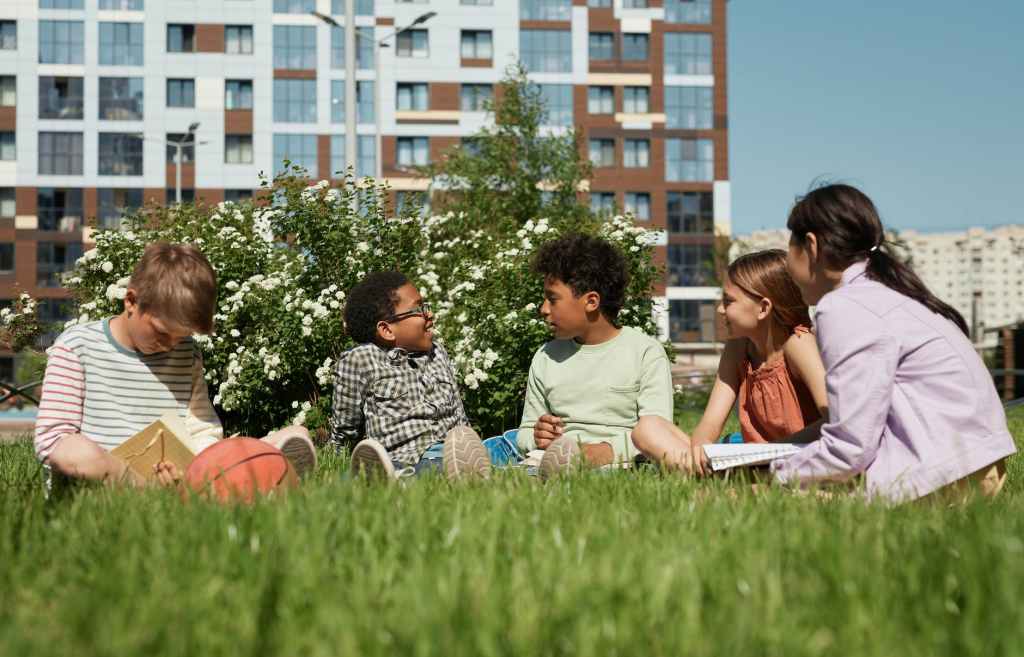 young people gather and relax in a field to chat